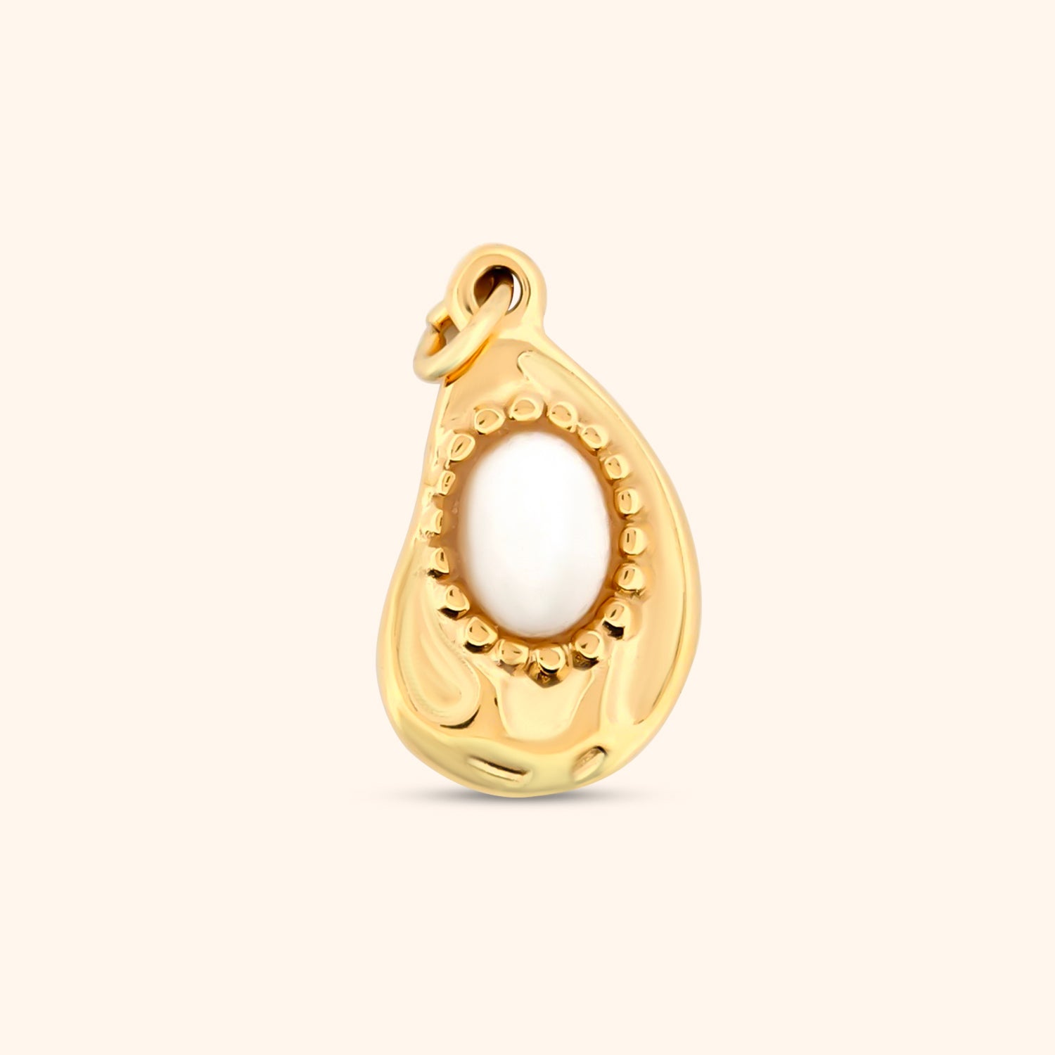Close-up of the Kinich Charm, a geometric gold charm featuring a small stone detail and intricate patterns.